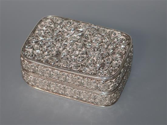 An Indian white metal rectangular box, all over repousse decorated with foliage, 88mm.